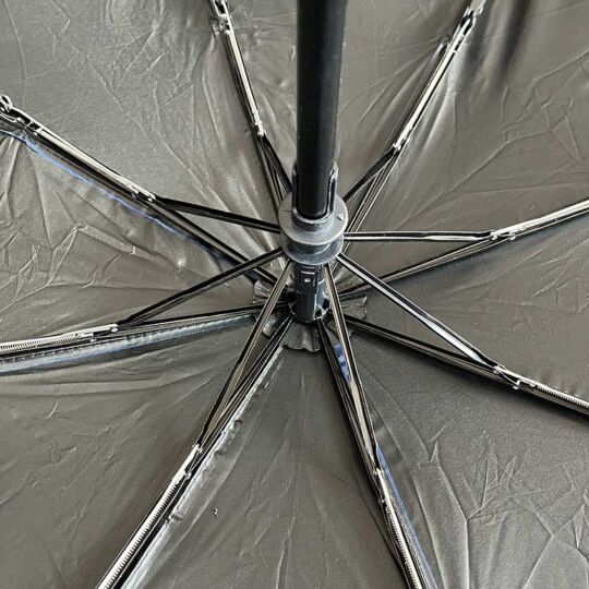 Polyester umbrella showing inside closeup of arms, opened with silver UV protector lining.