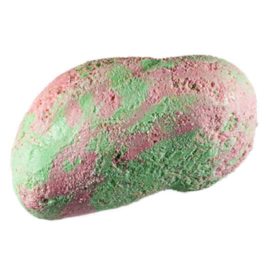 Pink and green piece of Taffy Bombs Freeze Dried Candy closeup can see texture.