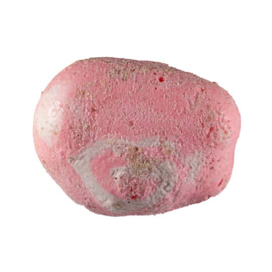 Pink swirl piece of Taffy Bombs Freeze Dried Candy closeup can see texture.