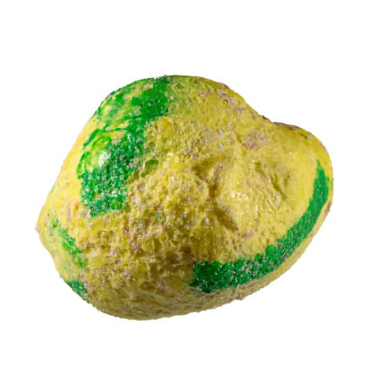 Yellow and green piece of Taffy Bombs Freeze Dried Candy closeup can see texture.